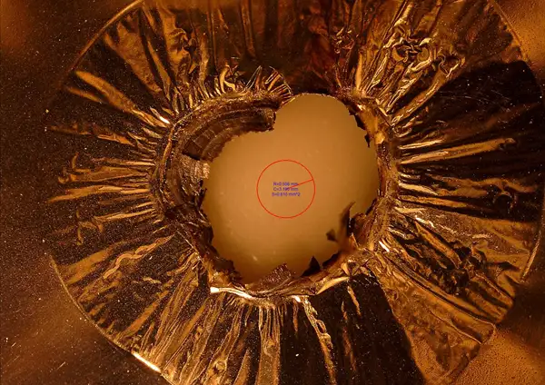 FIGURE 3. Metallized current collector after initiating a short (size of the short is the small red circle)